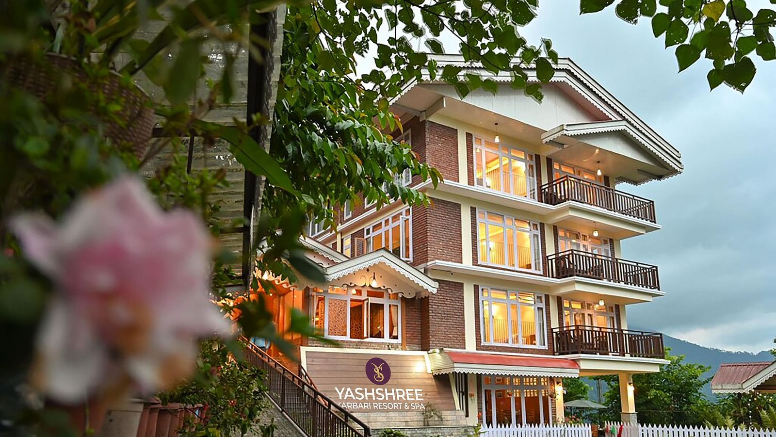 a beautiful facade image of the Yashshree Karbari Resort & Spa, Yangang with cloudy overcast skies in the background