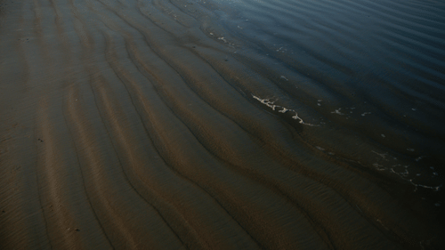 An overview of the soil of Colva Beach that is shown up in waves - South Goa Tourism