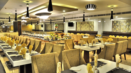 seating arrangements inside the in-house restaurant at Raj Park Hotel, Chennai