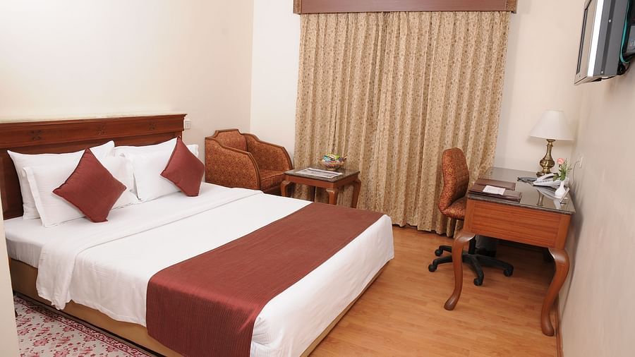 overview of a bedroom at Deluxe Room at Raj Park Hotel, Chennai