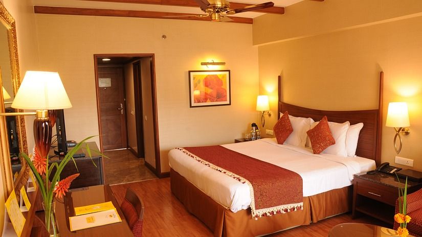 double bed in one of the rooms at at The Carlton Kodaikanal 