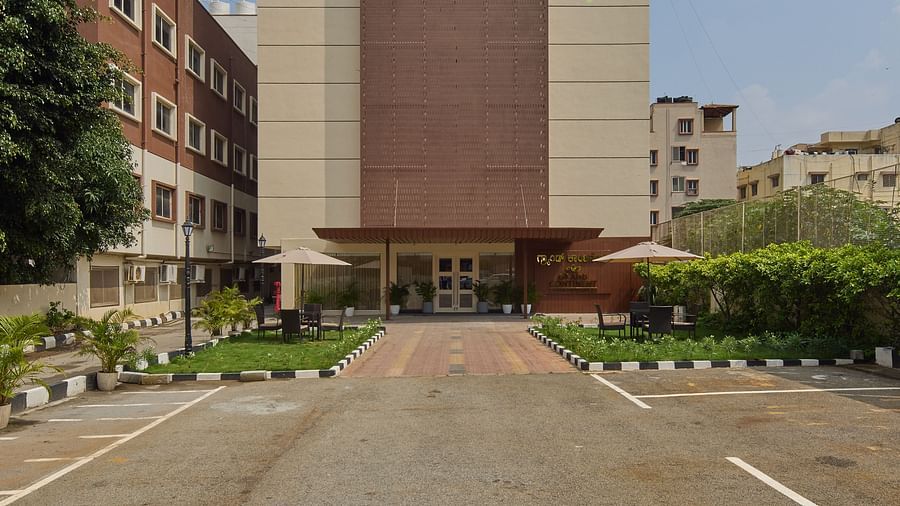 A front view of our hotel with modern architecture and greenery - Grand Continent, Brookefield