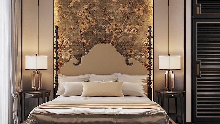 Front view of a well-made bed with cushions, a ceiling fan, and two bedside tables with lamps at The Evren, Vagator.