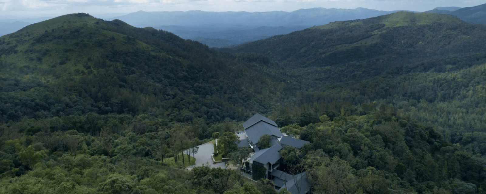 Aerial view of the Stanley Revelation estate with hills in the backdrop on a cloudy day.