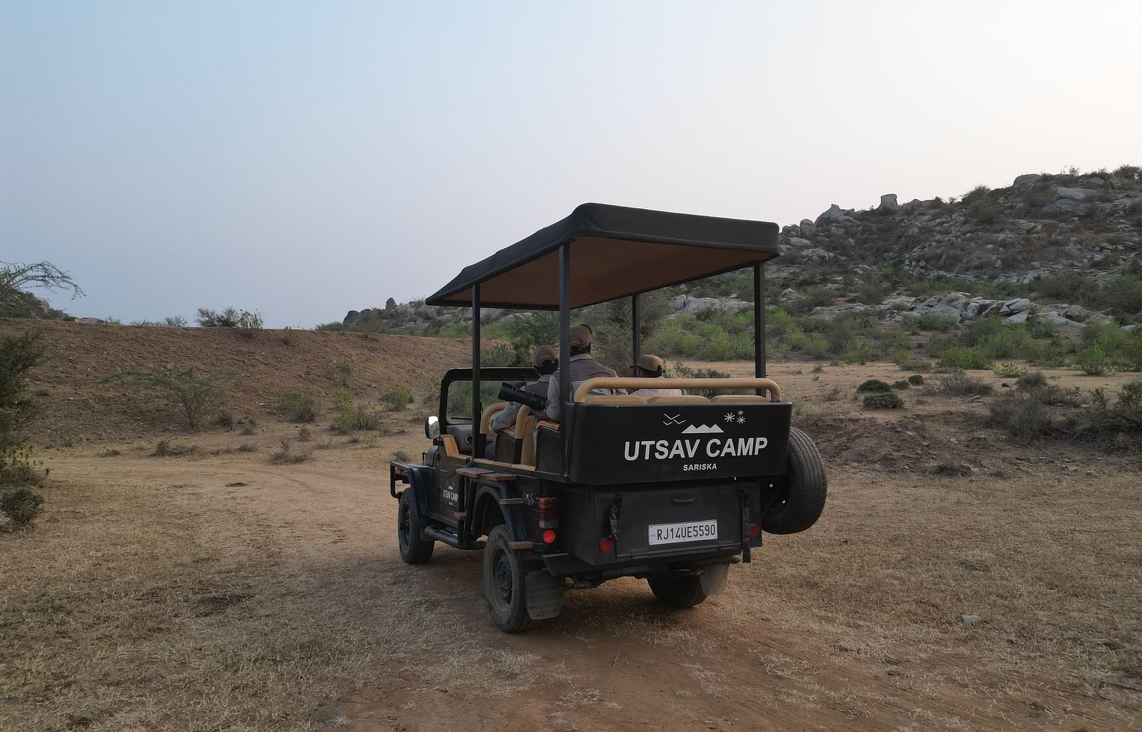 An image of a jeep parked amidst the rocky mountains - Utsav Camp Sariska