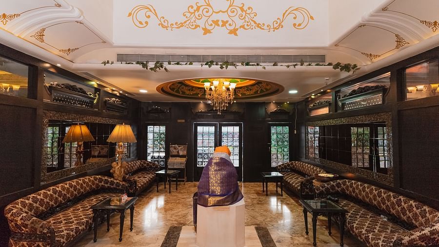 Lobby of Hotel Ashok Nagpur featuring a seating area with sofas and tables, and a wooden structure.