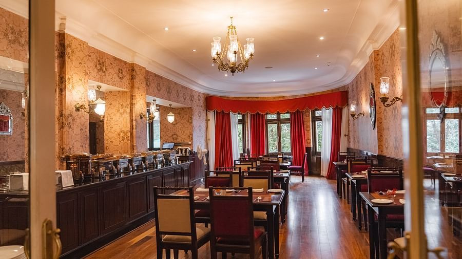 Spacious dining area with classic decor and vibrant lighting at The Claridges Nabha Residence
