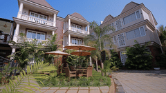 A lower angle of property view with green plants and trees infront of building-  Grand Continent, Anjuna - A Sarovar Portico Affiliate Hotel 