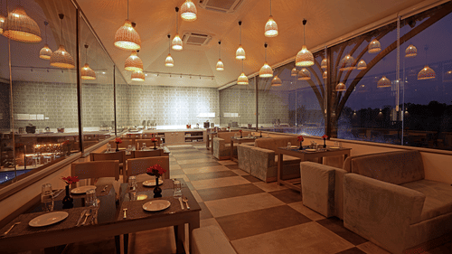 Interior view of the flavour multi-cuisine with with warm and seating arrangement at Grand Continent, Anjuna - A Sarovar Portico Affiliate Hotel  