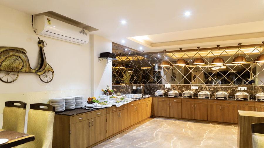 Image of a buffet table with crockery placed on the table at Amara Grand Baga, Goa.
