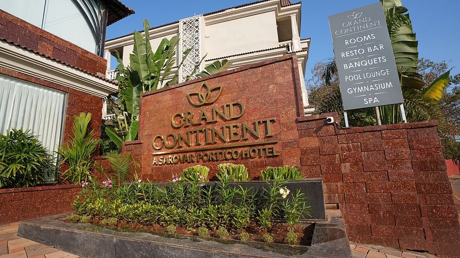 An exterior view of the hotel with a sign board - Grand Continent, Anjuna - A Sarovar Portico Affiliate Hotel 
