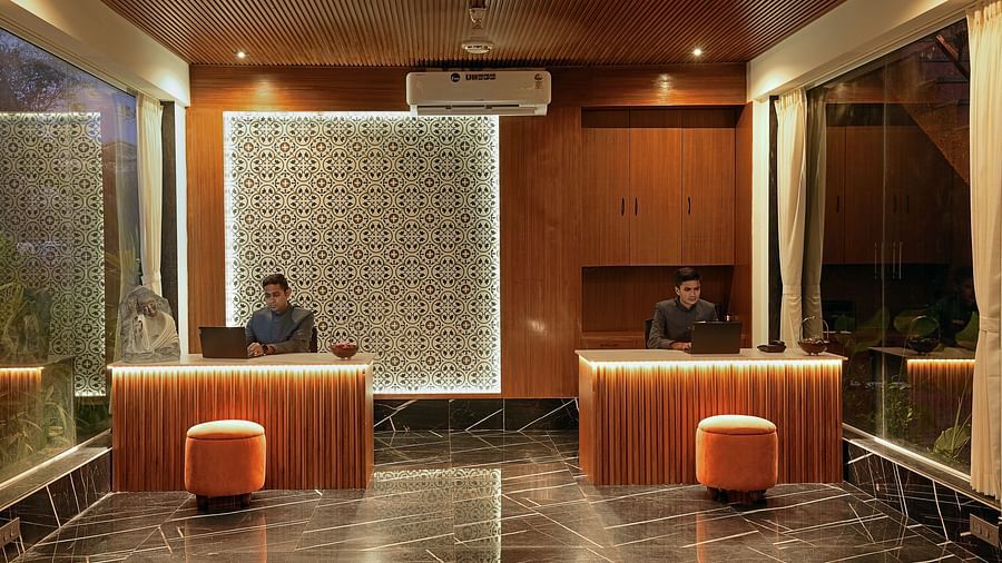 Receptionist standing near the reception table at Grand Continent, Anjuna - A Sarovar Portico Affiliate Hotel 