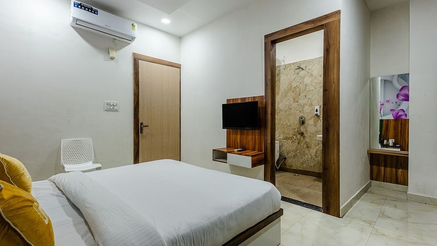 corner view image of the double bed with a bathroom with an open door at Lime Tree Hotels & Banquet Vrindavan