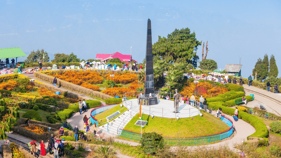 Landscaped gardens and the Batasia Loop war memorial monument near Tiger Hill in Darjeeling surrounded by colourful flower beds.