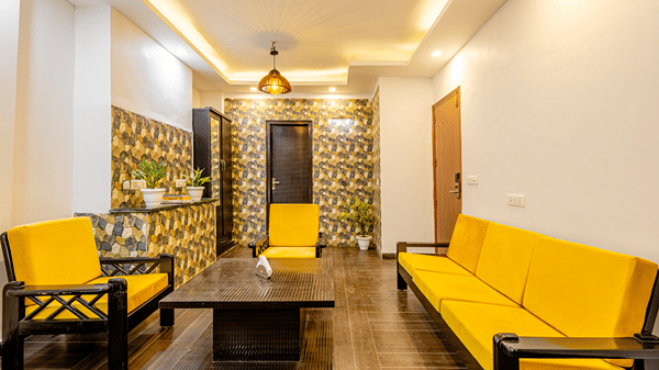 Modern hotel suite with a spacious seating area and elegant furnishings.