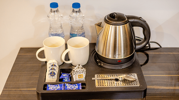 Complimentary tea and coffee maker with bottled water and refreshments in the hotel room.