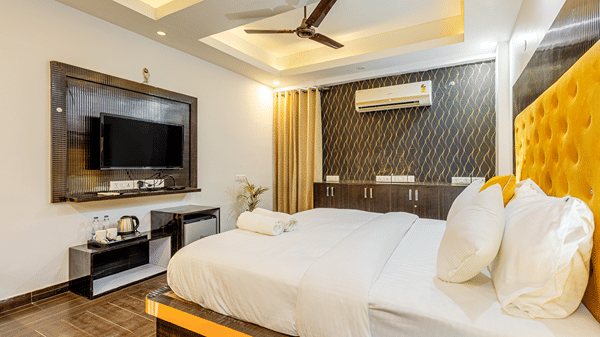 Luxury king room with contemporary interiors, television, and premium furnishings.