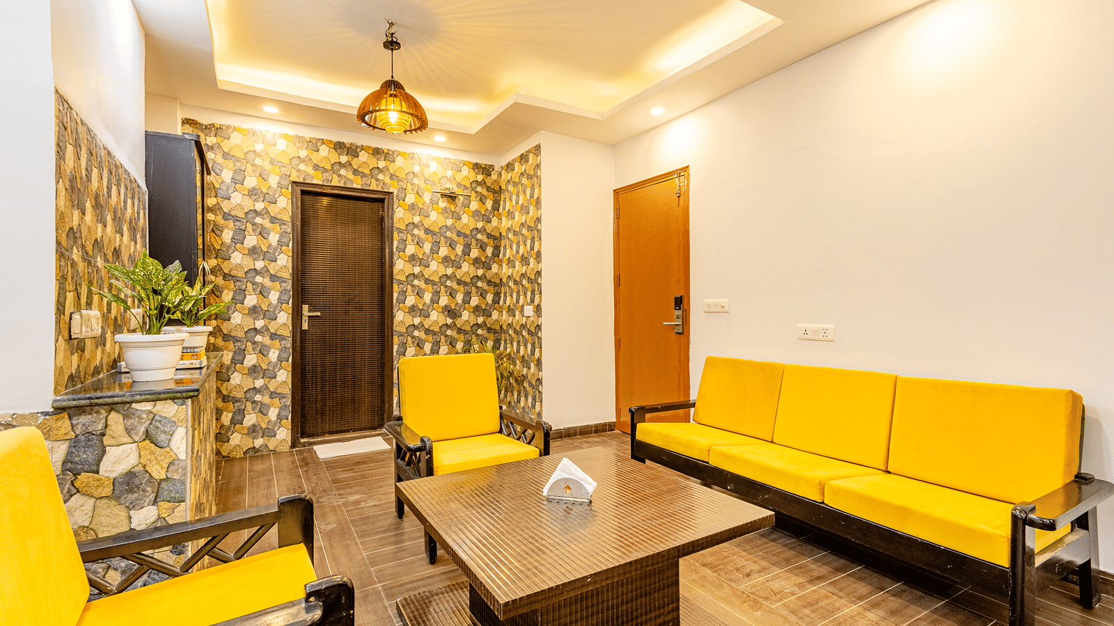 Spacious hotel suite with a sofa seating area and contemporary interiors.