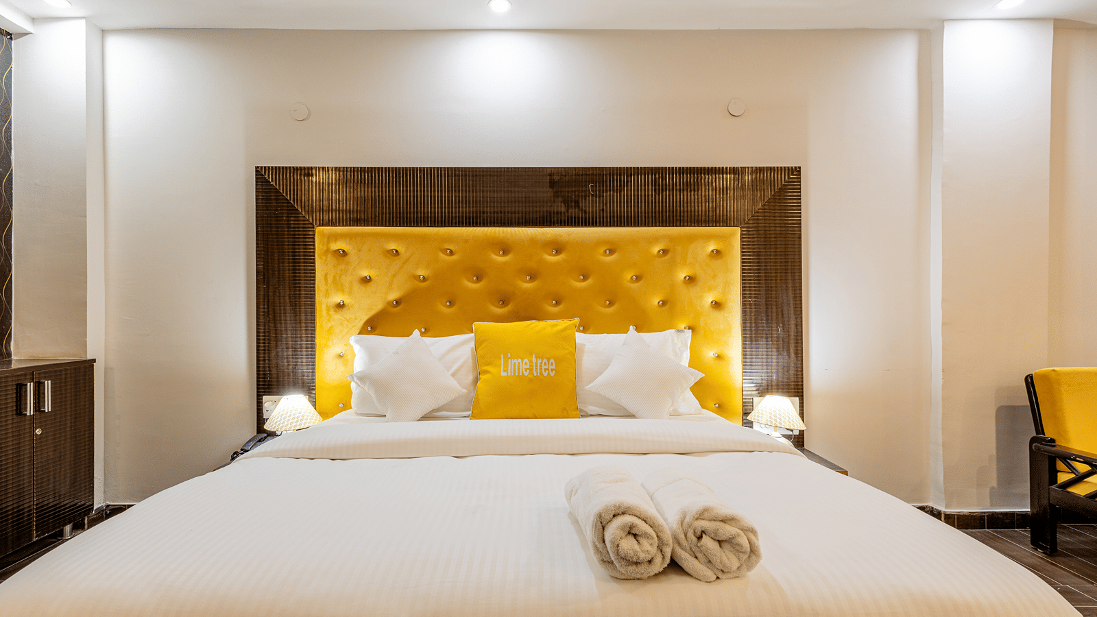 Front view of a king-size bed with premium bedding in a modern hotel room.