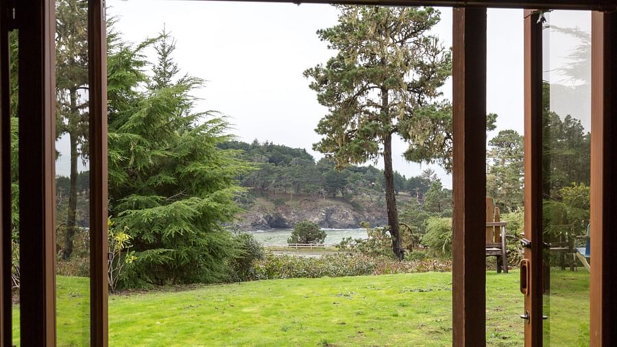 A breathtaking view of lush greenery through open French doors - Brewery Gulch Inn & Spa