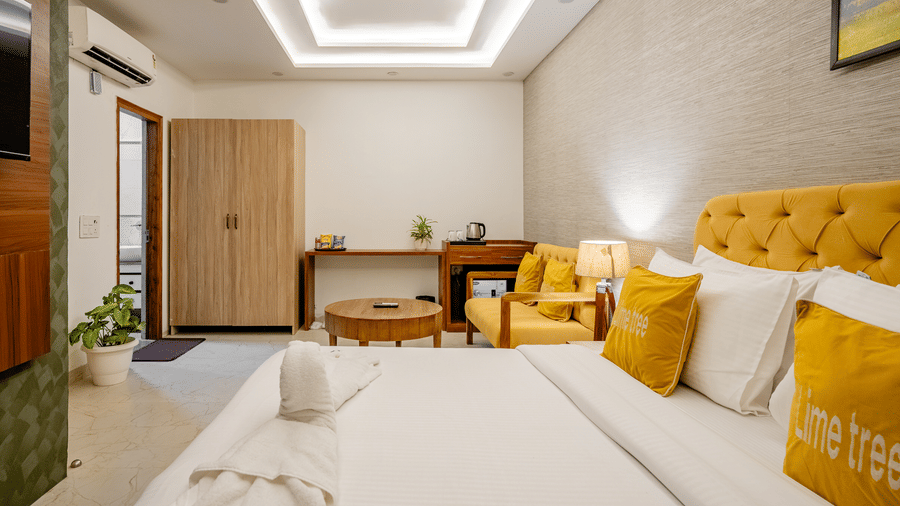 An overhead perspective of a premium hotel bedroom suite showcasing pristine white bed linen.