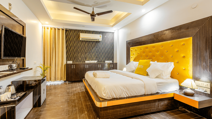 Wide angle view of the king size bed in the superior King room at Lime Tree Hotels and Banquet Hall Near Huda Metro, Gurgaon