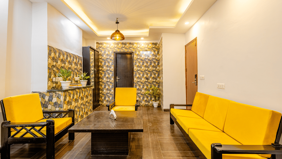 Modern hotel suite with a spacious seating area and elegant furnishings.