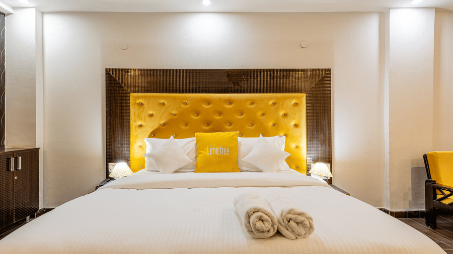 Front view of a king-size bed with premium bedding in a modern hotel room.