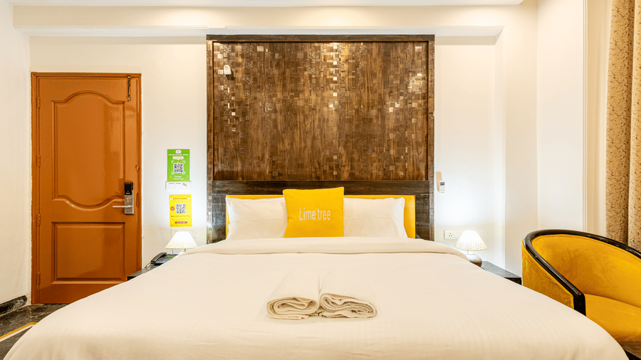 Front view of a spacious king room with contemporary decor and comfortable bedding.