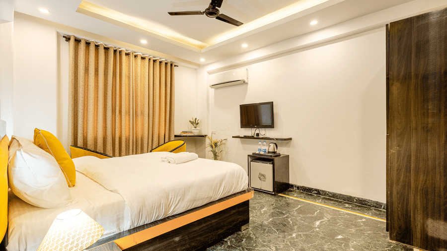 Modern king room featuring elegant décor, comfortable bedding, and a work area.