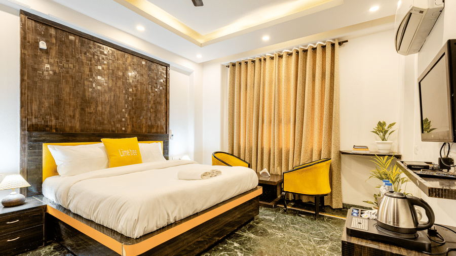 Premium king bedroom with contemporary interiors, television, and seating area.