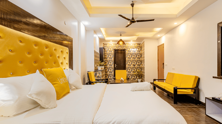 Comfortable  suite with a king bed, seating area, and contemporary interiors.