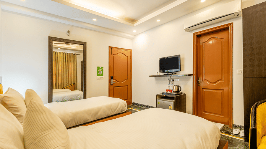 Twin-bed hotel room featuring modern amenities and contemporary décor