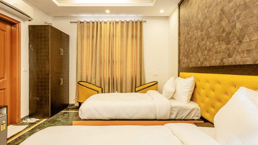 Comfortable twin-bed hotel room with a work area and stylish interiors.