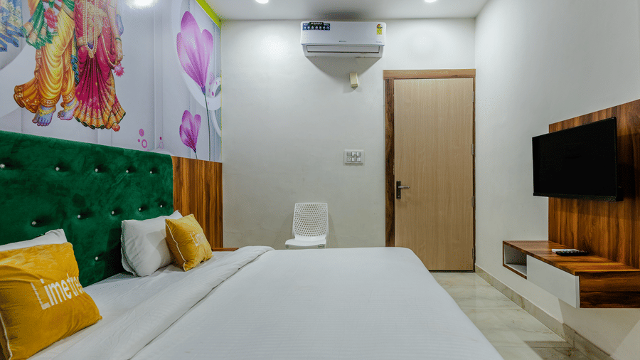 full vie image of the Brij Royal Deluxe Room at Lime Tree Hotels & Banquet Vrindavan with the entrance door at the far end