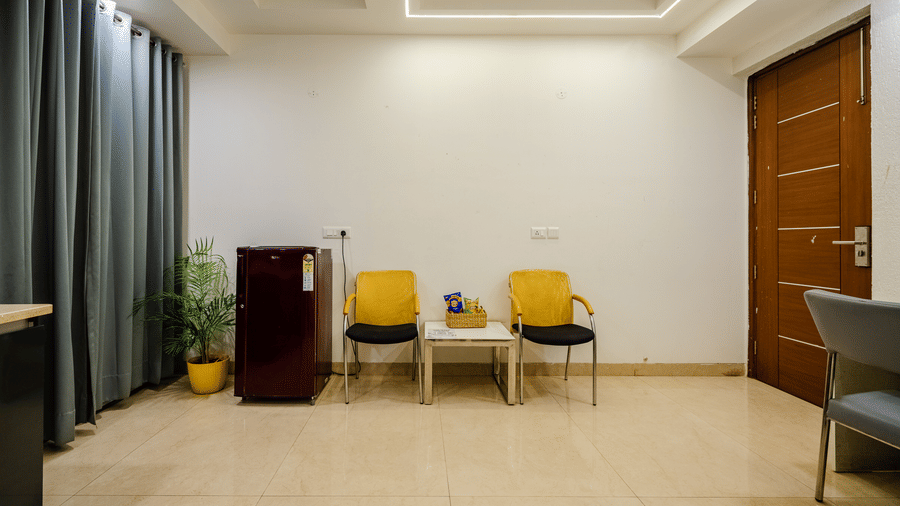 Lounge area of Lime Tree Luxury Studio featuring armchairs and a view towards the corridor.