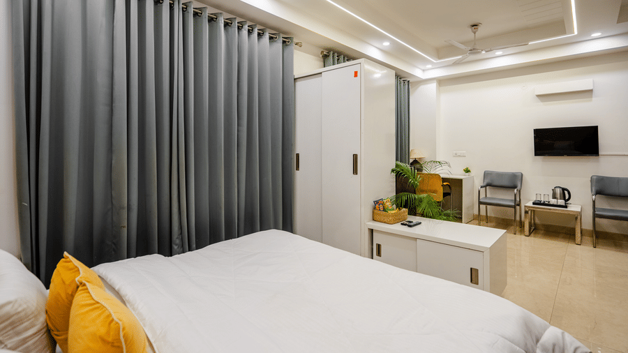 Bedroom of Lime Tree Luxury Studio featuring a headboard, curtains, and bedding.