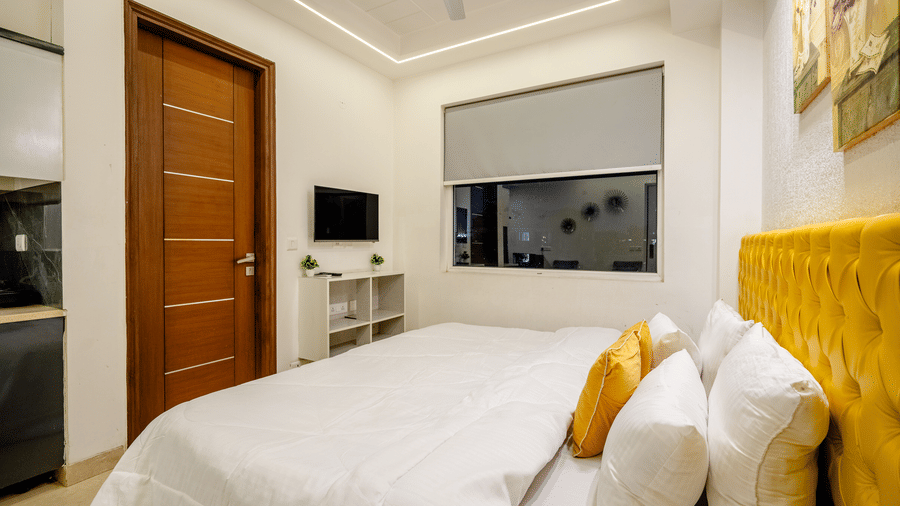 Bedroom of Lime Tree Luxury Studio featuring a headboard, a work desk, and a bedding.