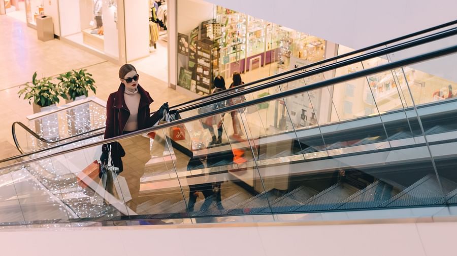 A woman coming up in an escalator