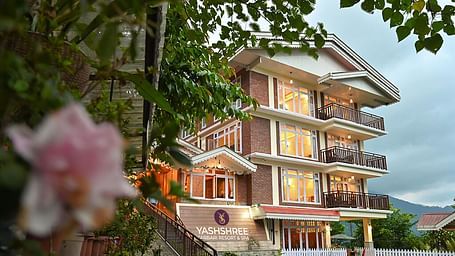 a beautiful facade image of the Yashshree Karbari Resort & Spa, Yangang with cloudy overcast skies in the background