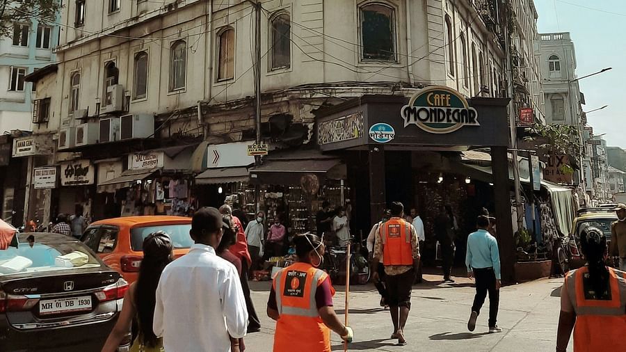 image featuring a building on a bright sunny day at the colaba causeway with people roaming around