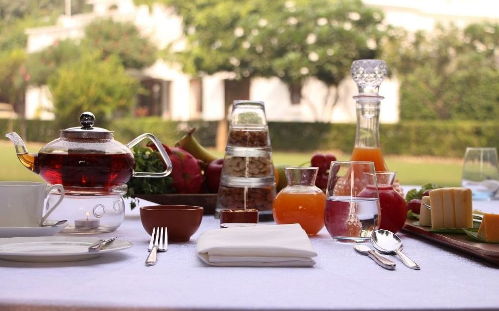 A variety of teas placed on a table with a garden in the backdrop