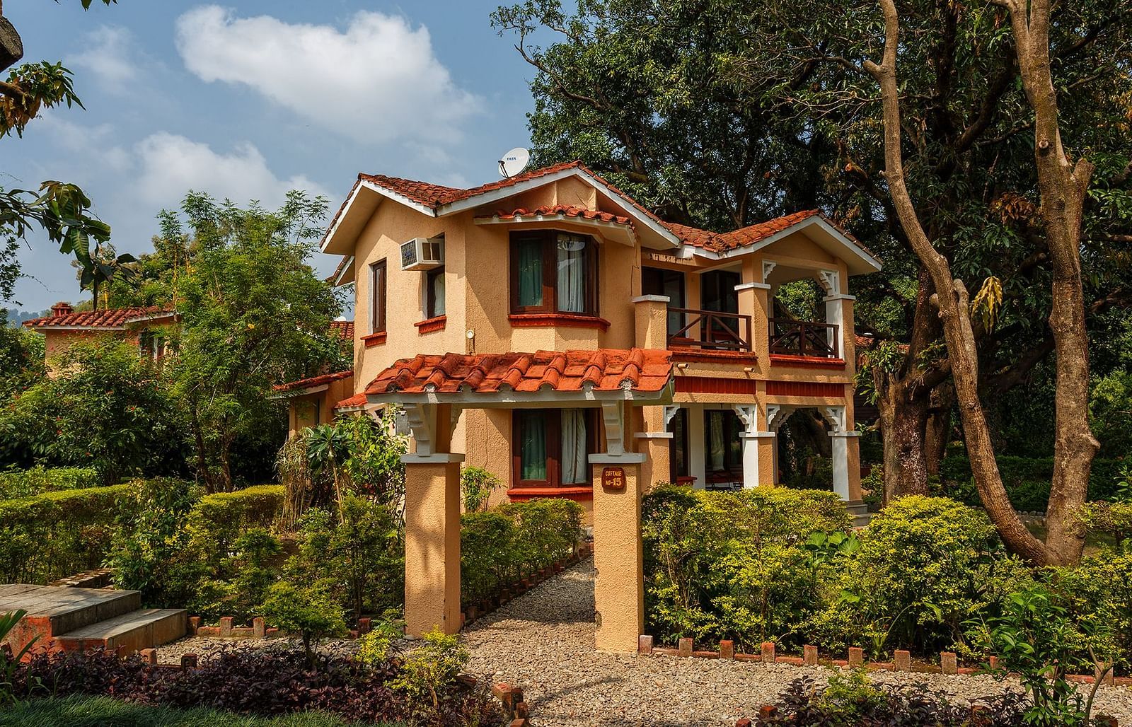 An image of a building with trees around in the day time