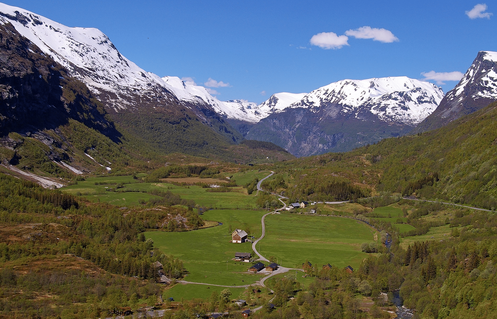 Image of mountain landscape with a valley and a river, captured in daytime