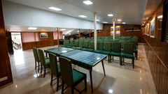 Row of green chairs in the conference hall at Himalaya Hotel, Nainital