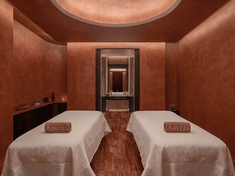 Spa treatment room with two massage beds set against warm toned walls at The Residency Signature Madurai.