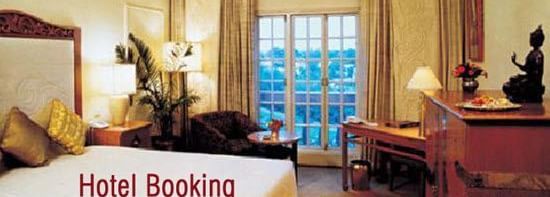 A hotel room interior with a large bed, sofa chair, a table, a cabinet and a table with the text 'Hotel Booking' on the image.