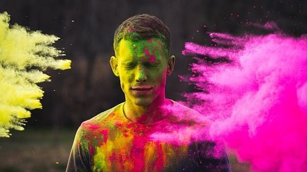 A person whose face is covered with several colours.