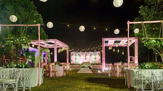 alt-text Event space with paper lanterns and fairy lights at night.