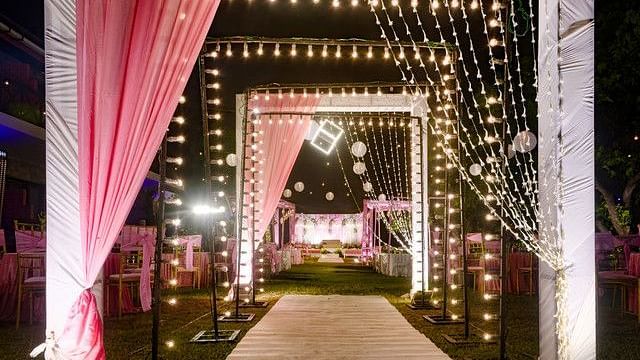 alt-text Festive entrance with fairy lights and floral arrangements.